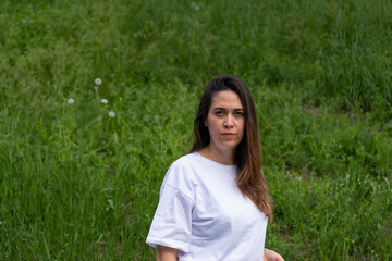 A young middle-aged woman in a white t-shirt with loose hair.