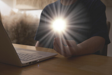 man hold light bulb lamp graphic  while use laptop computer in idea innovation power for solution...
