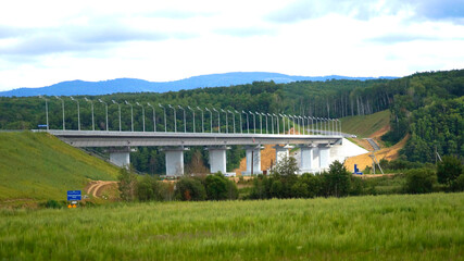 Automobile bridge across the Amur Bayou to Bolshoy Ussuriysky Island. Filmed on the border of Russia with China. Far Eastern region of Russia, Khabarovsk, Bolshoy Ussuriysky Island.
