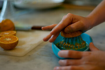 hand-squeezing fresh orange juice