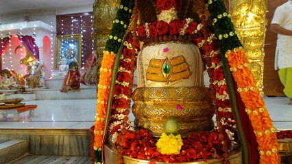 Tirupati, India 21st August 2022: Beautifully decorated Shivling. Devotees performing aarti and puja of Lord Shiva, Shiv ling or Lingam. Mahadev pooja in Shrawan or shravan maas.