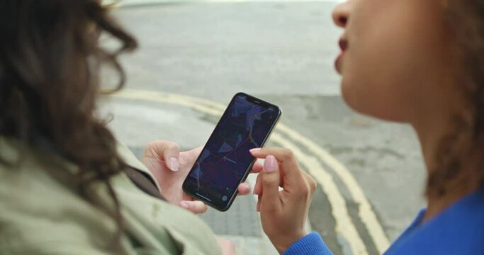 CU SLO MO Female friends using map on smart phone