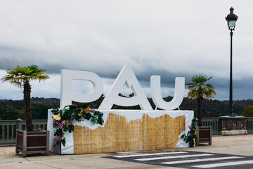 Ville de Pau, letters with name of the city on boulevard des pyrénées at cloudy day