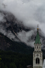 View of the bell tower of Cortina d'Ampezzo with clouds
