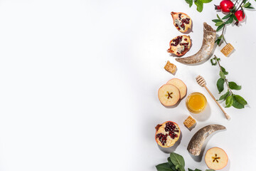 Happy Rosh Hashanah background. jewish New Year Rosh Hashana holiday postcard greeting background, with traditional religion symbols - apple, honey, pomegranate, shofar, flatlay copy space