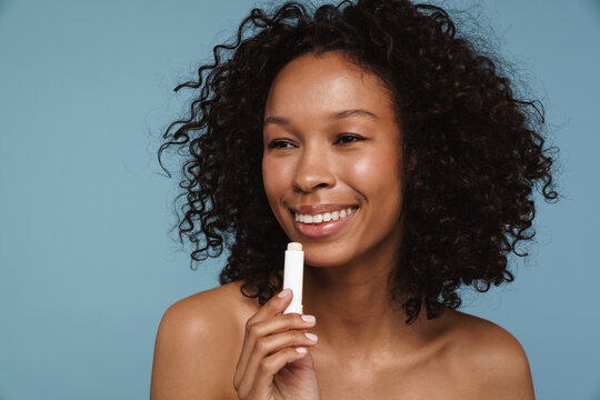 Shirtless Black Woman Smiling While Showing Lip Balm