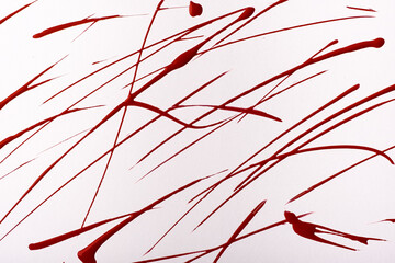 Thin dark red lines and splashes drawn on white background. Abstract art backdrop with wine brush decorative stroke.