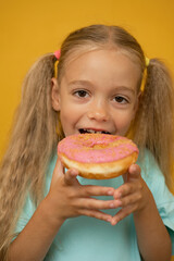 Funny girl with donuts on a yellow background