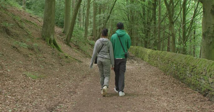 WS TS Teenage couple (16-17) walking in forest