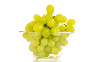 One bunch of white grapes in a glass bowl, close-up isolated on a white background.