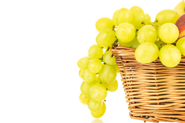 One bunch of white grapes  in a basket, close-up, isolated on a white background.