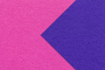 Fototapeta premium Texture of magenta paper background, half two colors with navy blue arrow, macro. Craft purple cardboard.