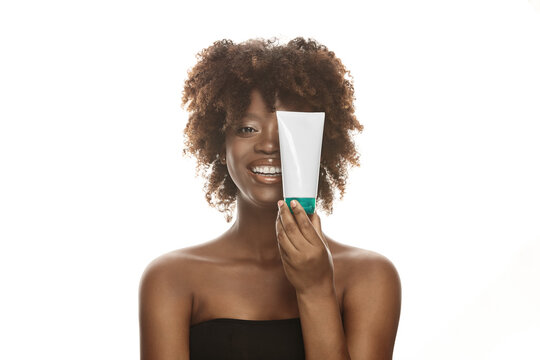 Girl With Brown Clean Skin Holds Tube Mockup.