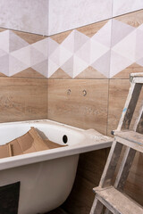 installing a new bathtub and laying ceramic tiles in bathroom. Repair