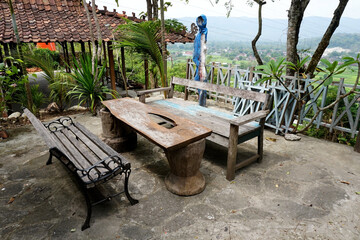set of wooden tables and chairs in the yard