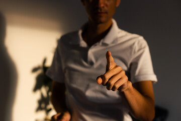 Young handsome man wearing casual t-shirt presenting with hand and pointing with finger.
