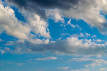 Dramatic blue sky and warm light clouds at sunrise time.