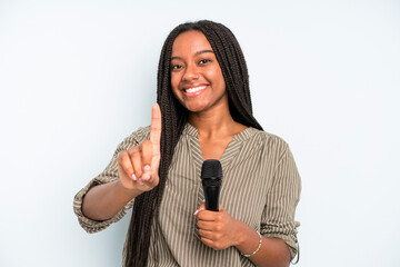 black pretty woman smiling proudly and confidently making number one. singer with a microphone