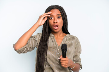 black pretty woman looking happy, astonished and surprised. singer with a microphone