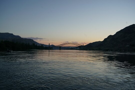 Beebe bridge on Columbia River in Washington before sunrise with blue sky and silhouettes of hills