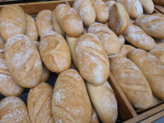 Bread loafs in bakery in bakery or grocery store. Freshly baked in