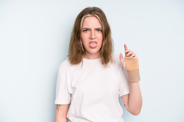 caucasian pretty woman feeling disgusted and irritated and tongue out. broken hand concept