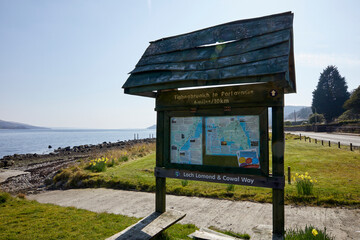 March and a bright, backlit view of the community visitors notice board on the shore of Loch Ruel in Tighnabruaich. Argyll and Bute