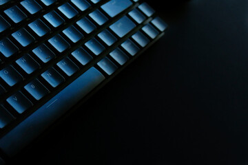 Black mechanical keyboard on a black desk 