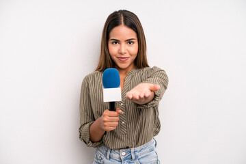 hispanic pretty woman smiling happily with friendly and  offering and showing a concept. presenter...