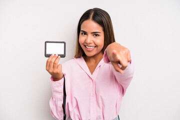 hispanic pretty woman pointing at camera choosing you. pass id card concept