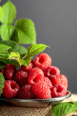 Raspberries in a small metal dish.