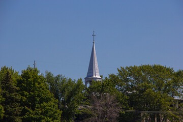Historic parish church spire behind trees