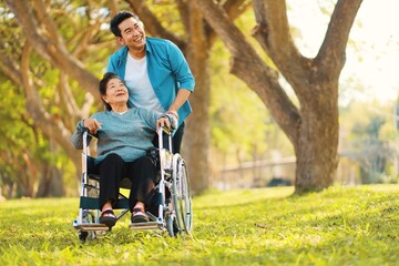 Fototapeta premium Portrait smiling Asian man hug Senior woman, Happy mother and son at outdoors. Nature background.