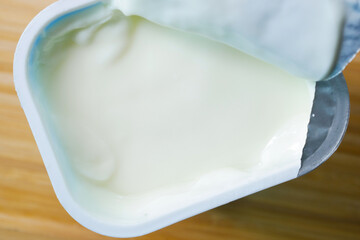 fresh yogurt in a plastic container close up 