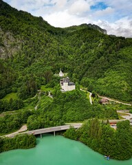 Beautiful view of the majestic Klaus castle on green hilltop, on riverbank, Austria