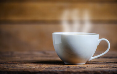 A cup of coffee with coffee bean on wooden background