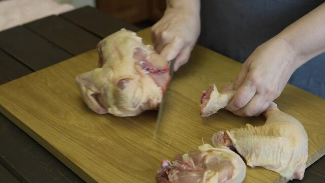 woman carving chicken in the kitchen