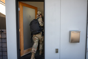 Air Force service member gets ready for work and leaves.