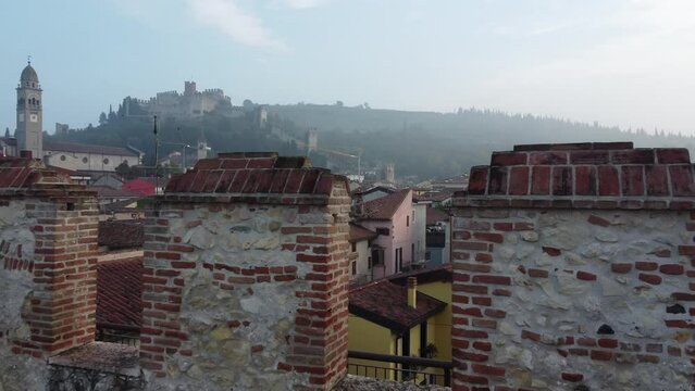 Drone footage over the old wall to the Veneto cityscape under the blue sky
