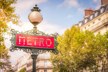 Fototapeta na wymiar Ornate retro Metro sign entrance in Paris at sunrise, France