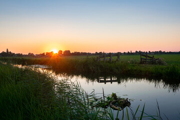 The sun goes down over the watery Dutch landscape in the western part of the country.