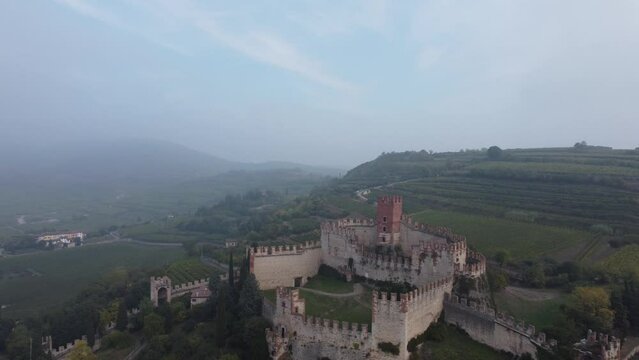 Drone footage of castle of Soave restored medieval building under the blue sky