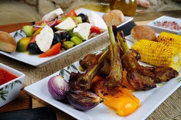 Rack of lamb with corn and Greek salad. Homemade food. Rustic.