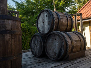 three wooden barrels on deck, covered with rope and iron