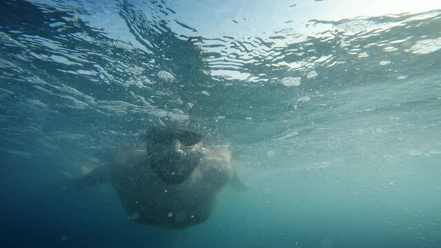 Boy struggling to swim in rough sea
