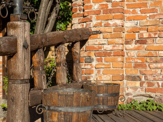 wooden buckets standing near the wall and wooden fence