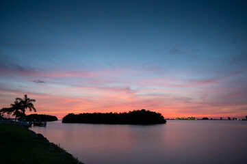 Sunset along river in Florida with silhouette of Mangrove Island
