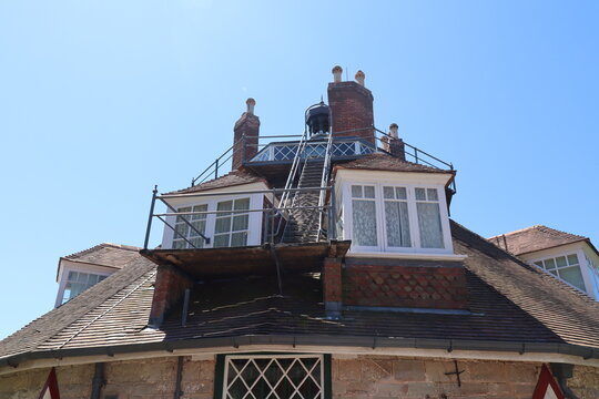 The windows in the roof of an unusual historic sixteen sided house on a beautiful sunny summers day in Devon, England.
