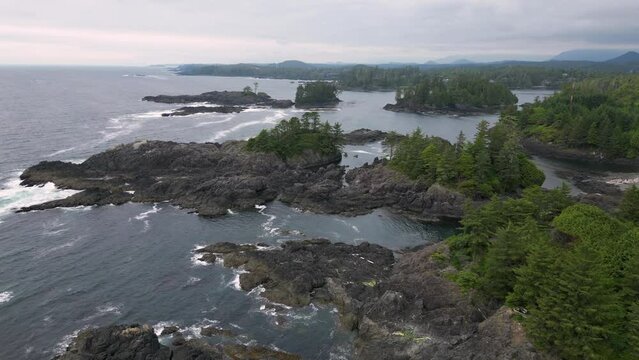 Aerial view of ocean waves splashing on rocks in Ucluelet, BC, Canada