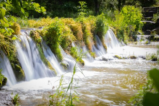 Scenic Shot Of A Waterfall In Texas Surrounded By Fresh Vegetation